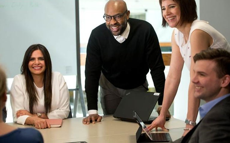 A diverse group of people around a boardroom table