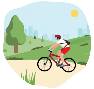 Man cycling through a park in the city