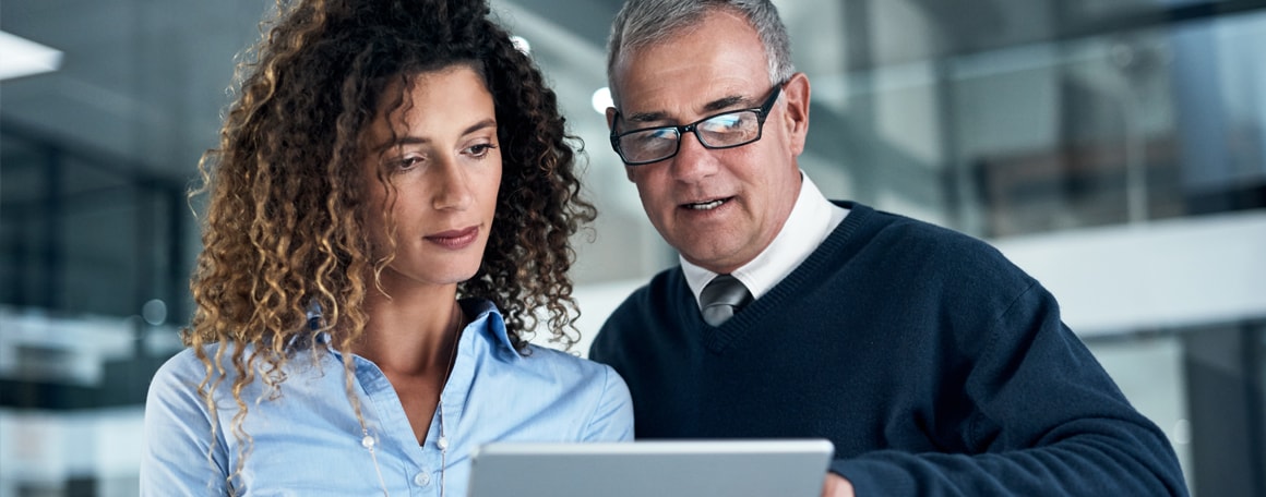 Two business people looking at tablet