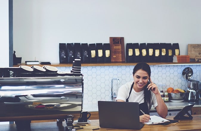 Customers on a laptop at a coffee shop