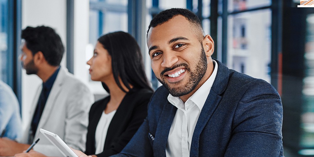 Man smiling while in a meeting.