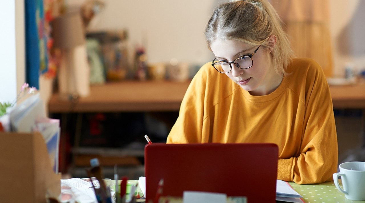 A young woman studying at her desk