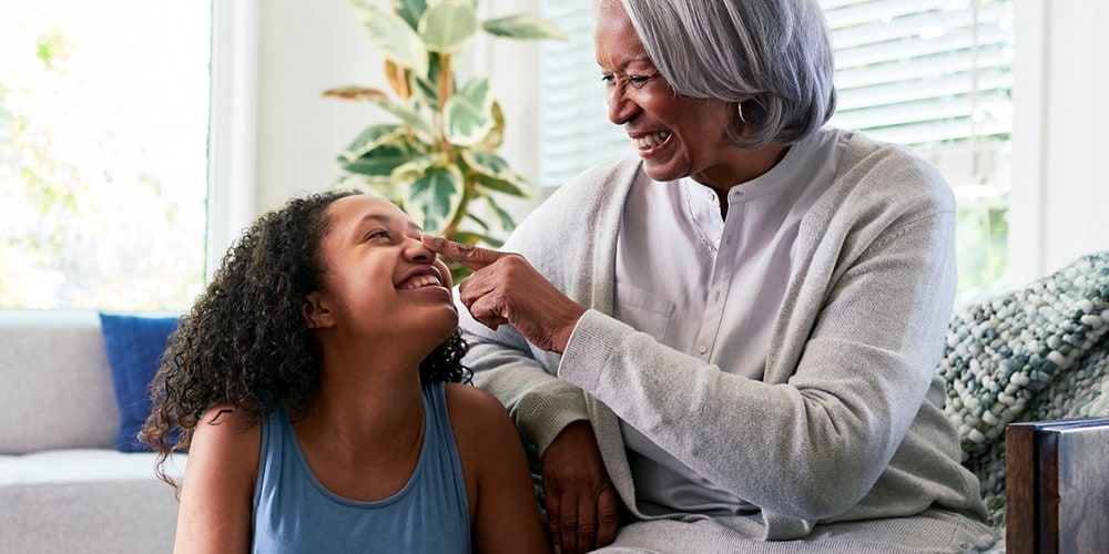 A grandmother being playful with her granddaughter