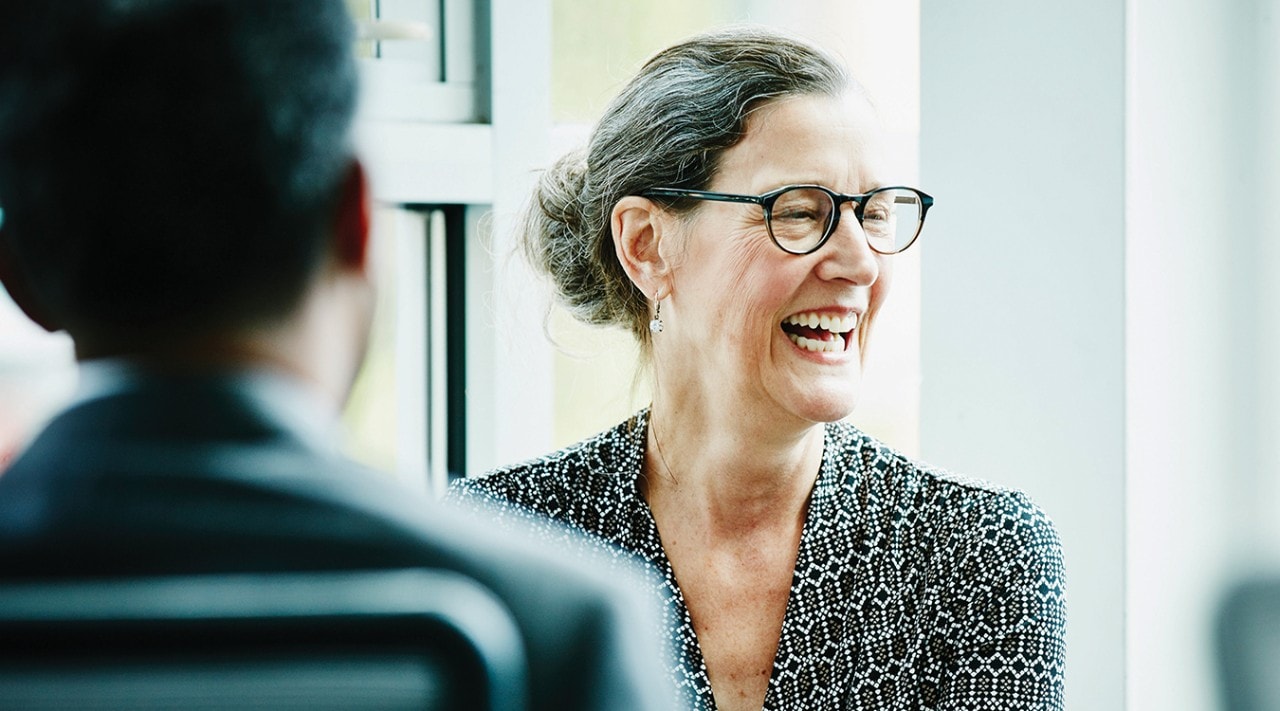 Woman laughing in a meeting