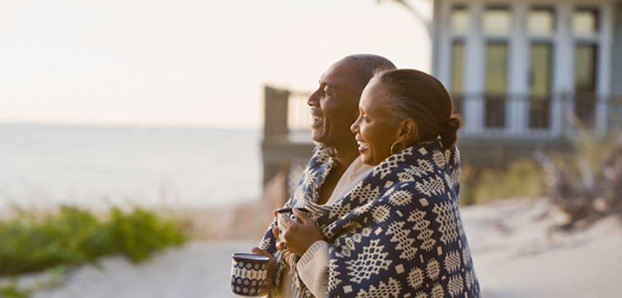 An older couple on the beach admiring the view.