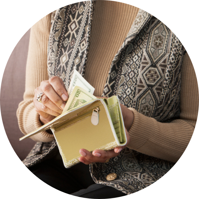 A woman counting cash in her wallet.