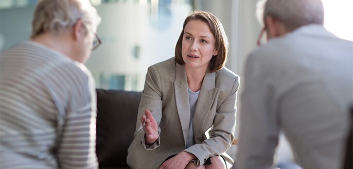 An advisor meeting with her clients
