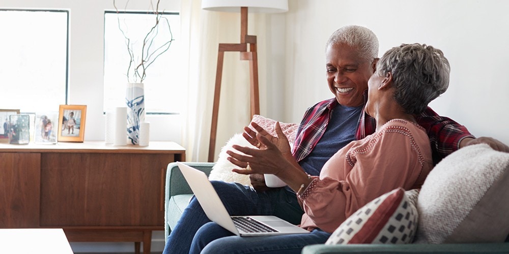 older couple laughing on couch