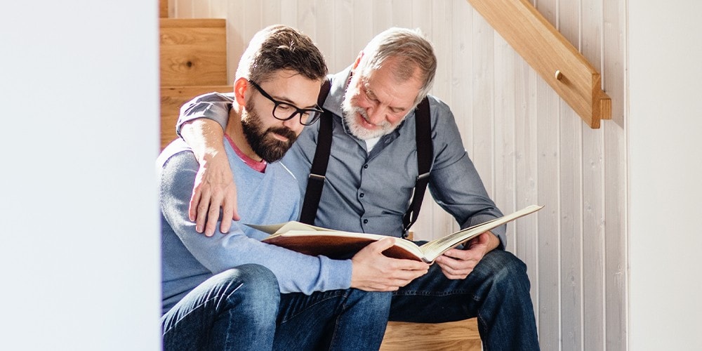 A father and son looking through a photo album