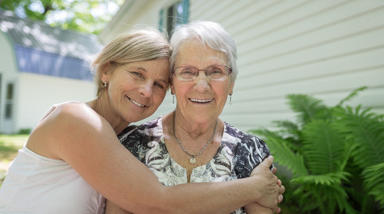 A grandmother and granddaughter looking through a photo album