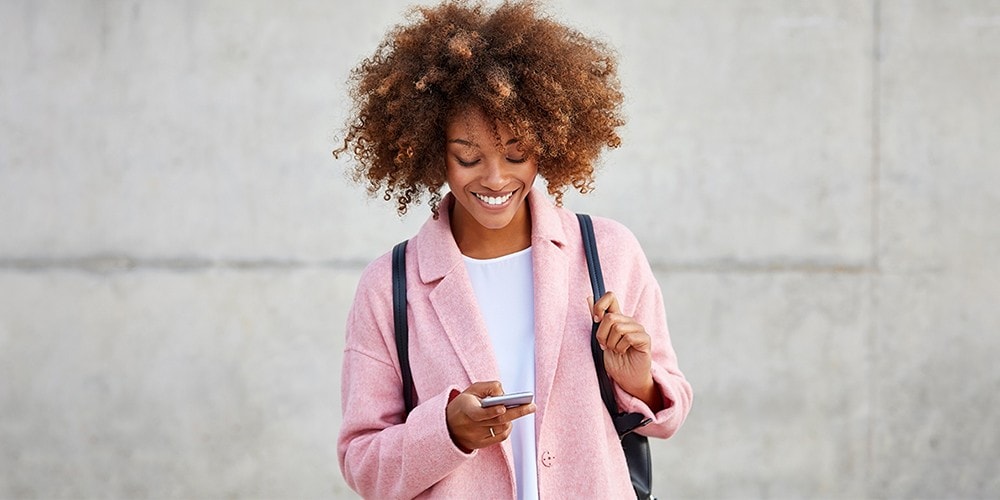 Woman looking at the CIBC mobile app on her smartphone