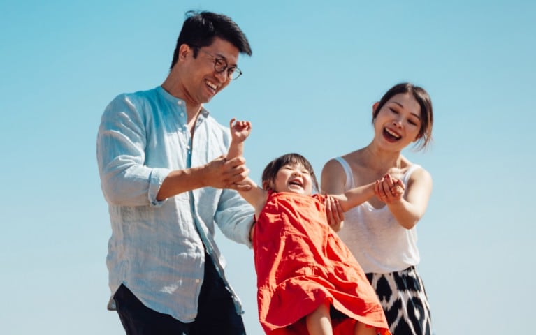 A mother hugging her 4 children.