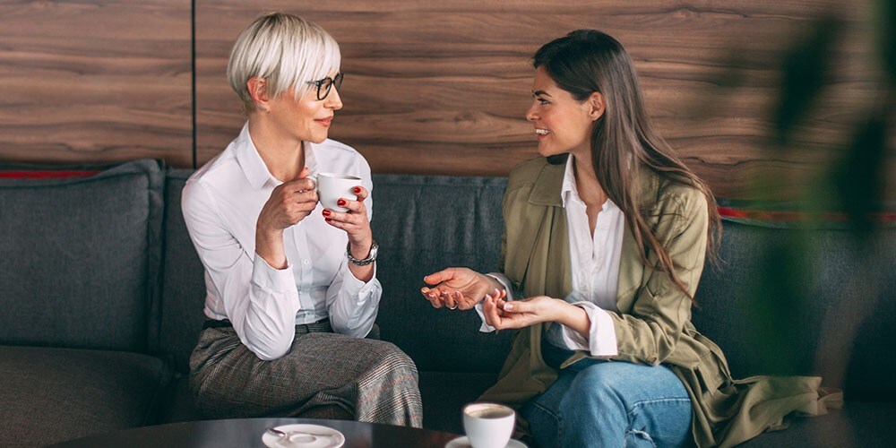 Two women chatting over coffee