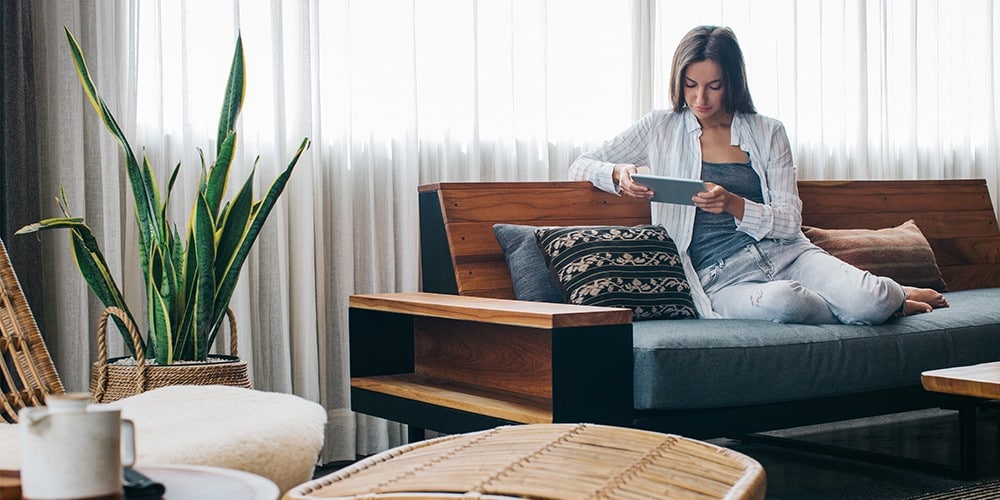 Woman at home looking at CIBC site on her tablet