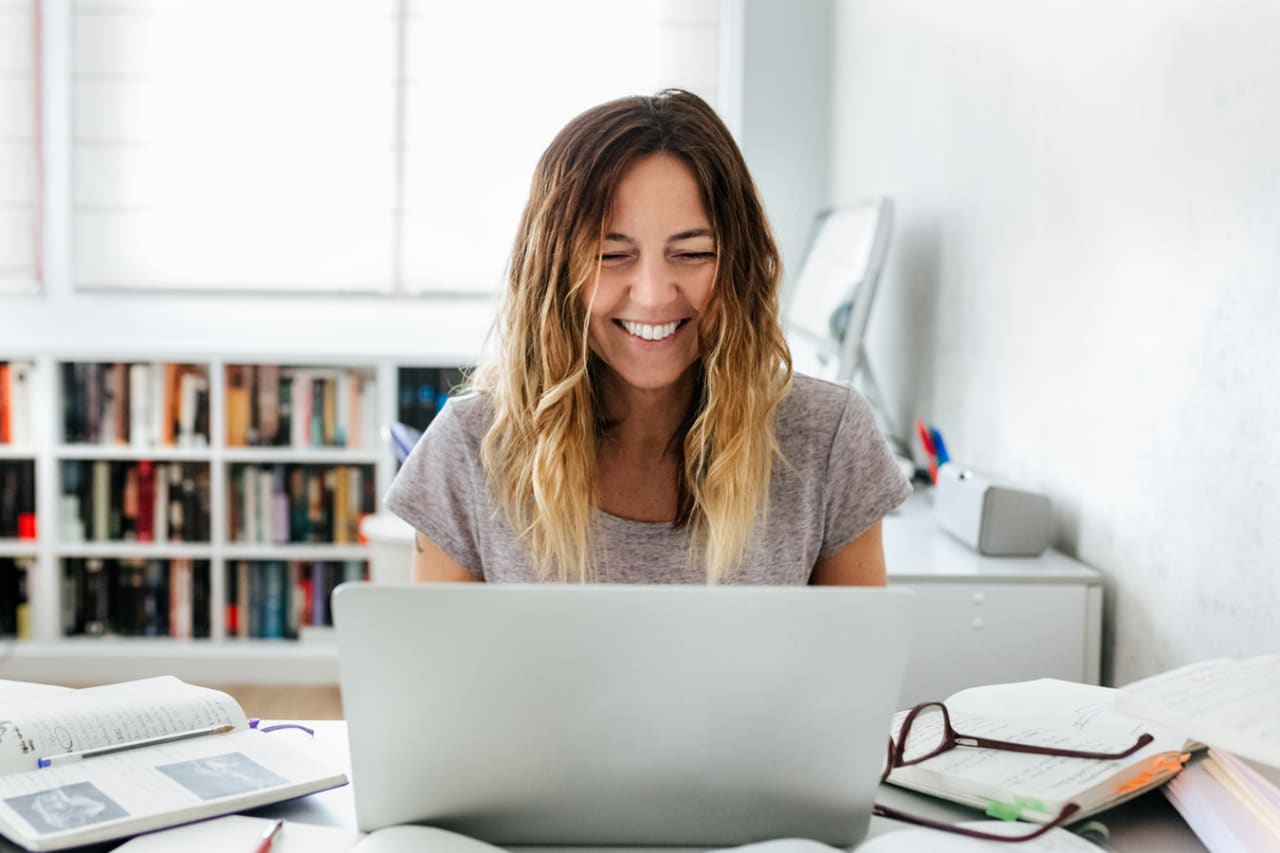 Happy person checks their digital vault on a laptop