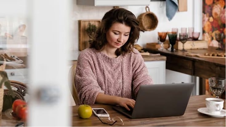 Happy person checks their digital vault on a laptop