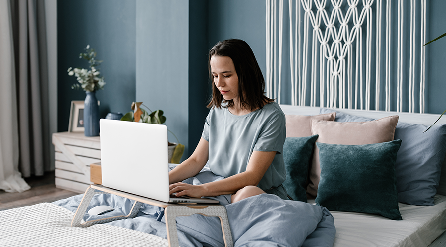 A client does their banking on a laptop at home