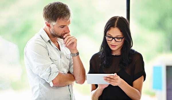 Man and woman reading on a tablet