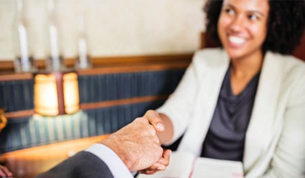 Woman shaking someone's hand