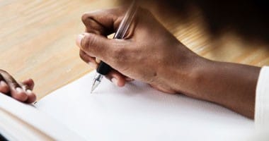 Woman writing a business plan in her notebook