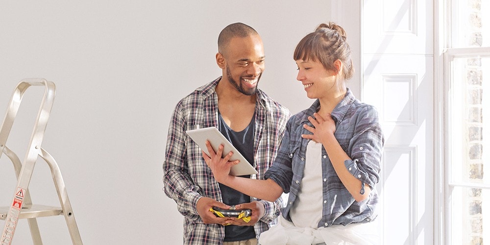 A couple getting ready to paint a room in their new home.