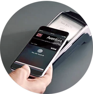 person holding a phone, using Apple Pay to pay with their CIBC credit card
