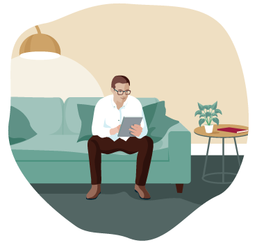 a man sitting on a couch using a tablet