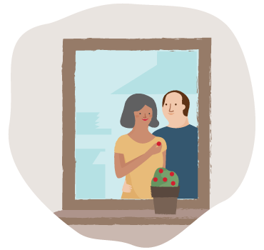 A couple staring into a mirror while the woman holds a flower