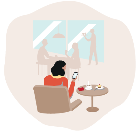 A Woman sitting in a café looking at her phone.