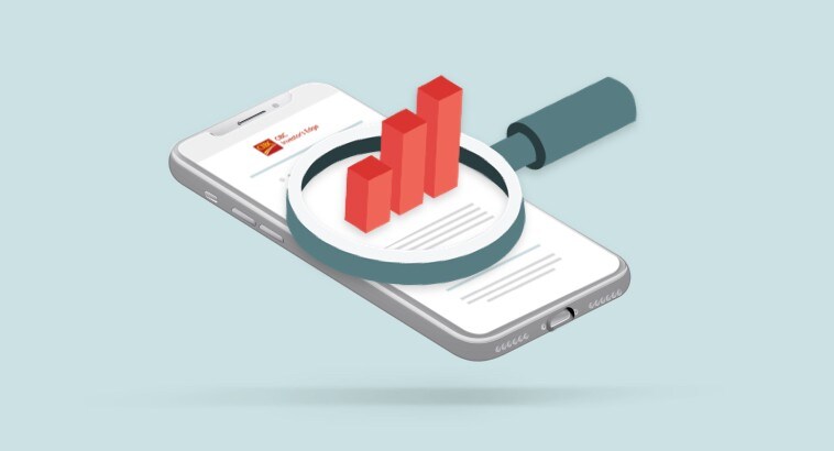 Smartphone screen with magnifying glass showing a graph with growing investments