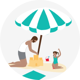 Un père et sa fille construisent un château de sable sur la plage