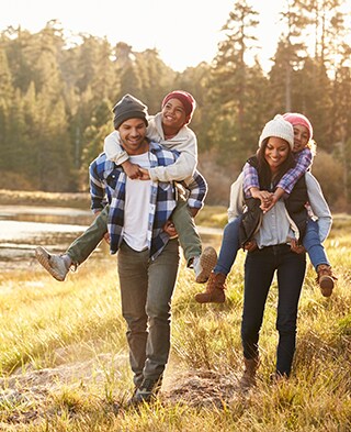 A happy young family plays in a park