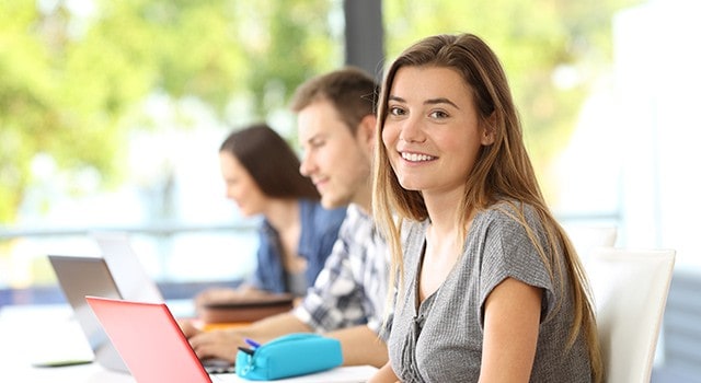 Students in class with their laptops.