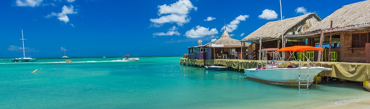 A dock next to turquoise waters in Aruba.