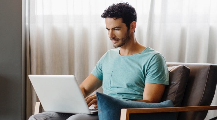 Man at home checking his investments on his laptop