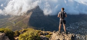 Climber conquers mountain and stands on its peak